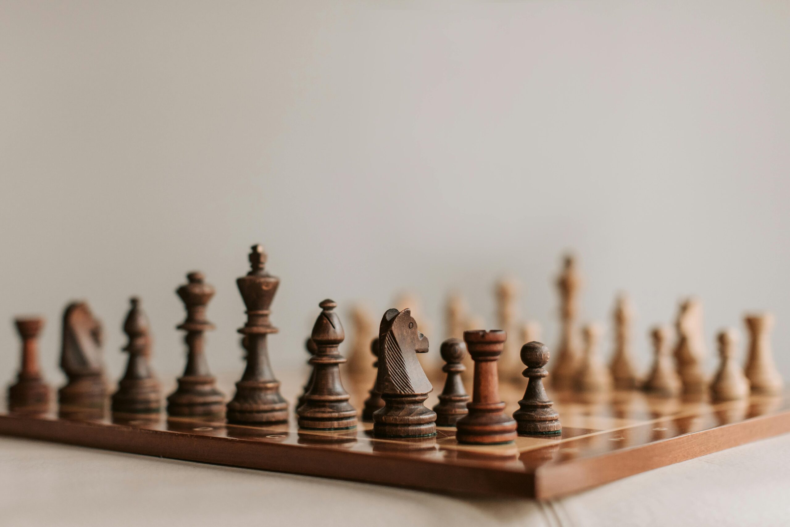 Close-up of a classic wooden chess set, showcasing the intricate design and craftsmanship of each piece.